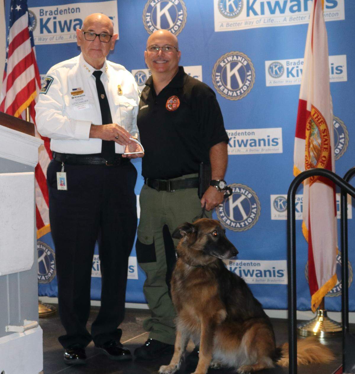 Manatee County Search and Rescue was one of 23 public safety agencies saluted for their service Sept. 6 by the Bradenton Kiwanis Club. Shown above are Steve Litschauer, deputy director of Manatee County Public Safety, (left) with John Elwood, deputy chief of Manatee County Search and Rescue, and “Karma,” who has been credited with nine saves and five assists.