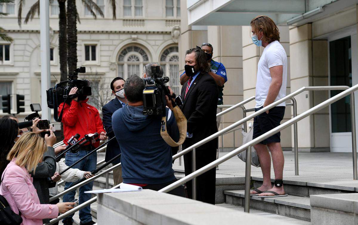 01/11/20--Adam Johnson, in shorts, emerges from the Tampa Federal Courthouse after an appearance Monday, wearing an ankle monitor.