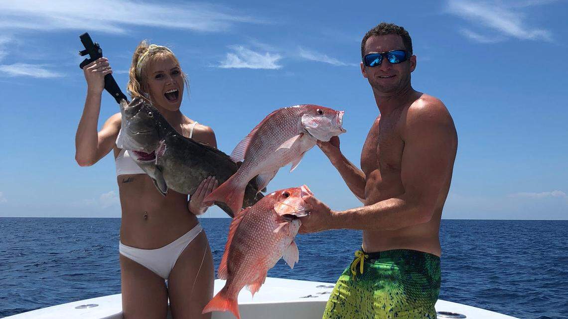 Capt. Jack Vasilaros and girlfriend/co-captain Emily Riemer showing their catch of red snapper.
