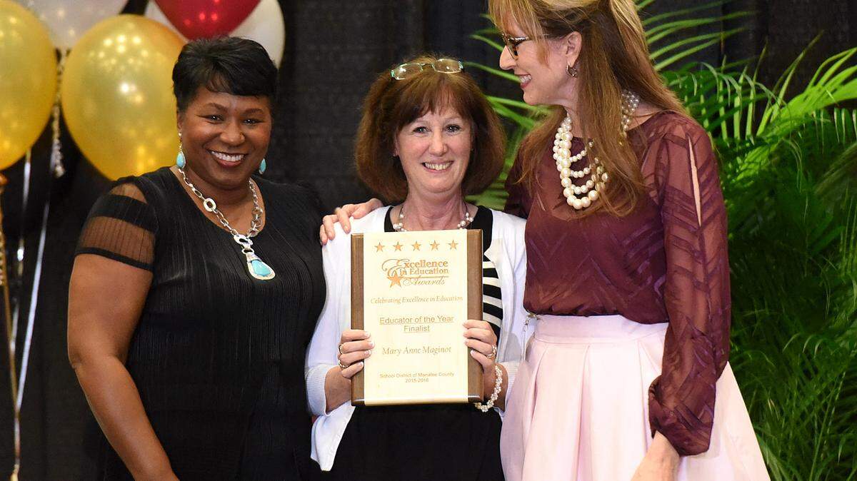 Superintendent Diana Greene and Deputy Superintendent of instruction Cynthia Saunders flank Educator of the Year finalist Mary Anne Maginot at the Excellence in Education Awards at MTC Wednesday night. 
 TIFFANY TOMPKINS/Bradenton Herald