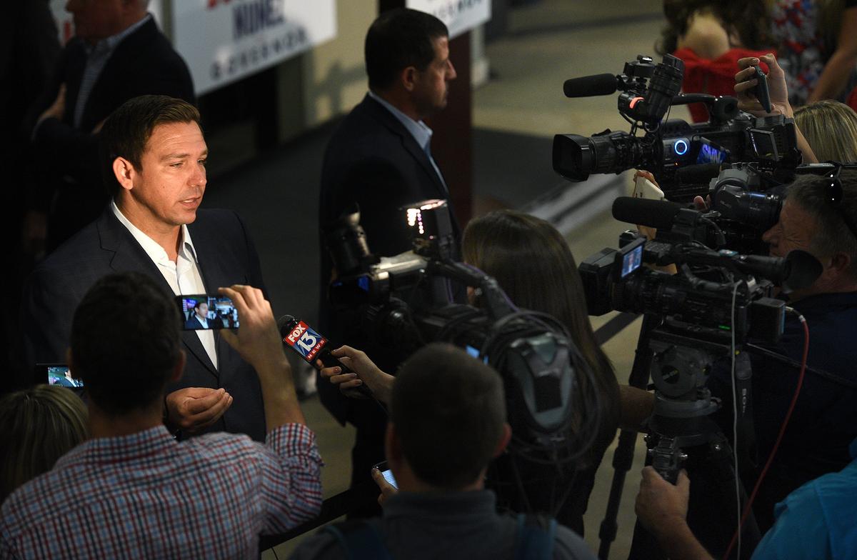 Republican candidate for governor, Ron DeSantis, talks to the media during a campaign rally stop at Dolphin Aviation Wednesday morning.