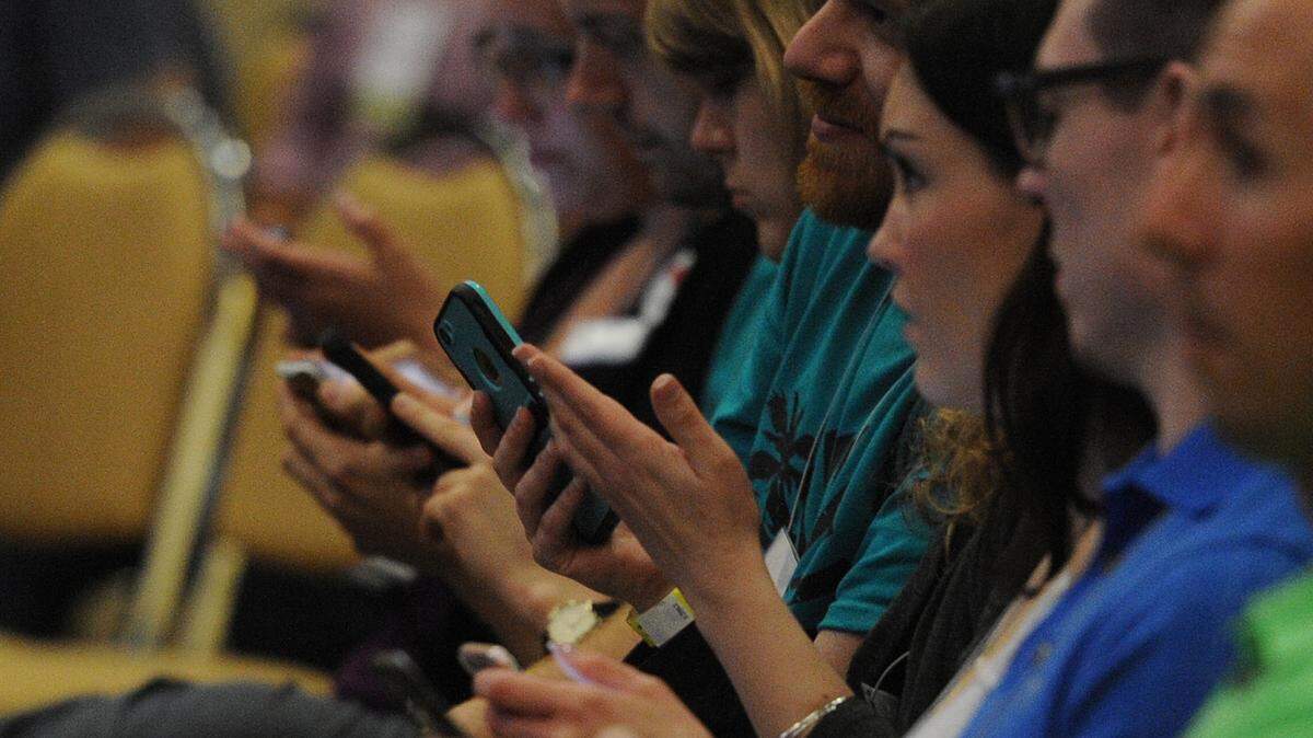 Millennials use their smart phones to respond to questions during a panel discussion on the barriers to millennial housing at the #4Progress Millennial Con in April 2016 at the Bradenton Area Convention Center in Palmetto. 
 GRANT JEFFERIES/Bradenton Herald