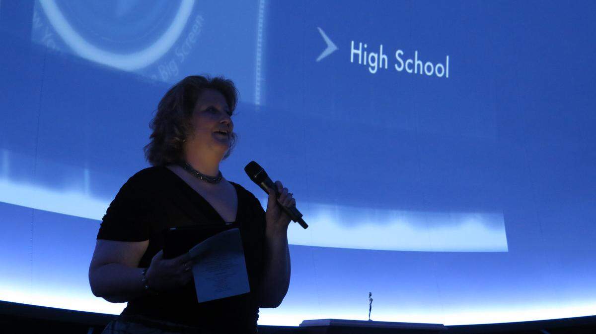 Marie Masferrer, president of the Manatee Association for Media in Education and a media specialist and TV production teacher at R. Dan Nolan Middle School, speaks to the crowd of students, teachers and sponsors at the Film Rush 2014: A Jim Harbin Student Media Festival. The festival showcased films by K-12 students from Manatee County School District.AMARIS CASTILLO/Bradenton Herald File Photo