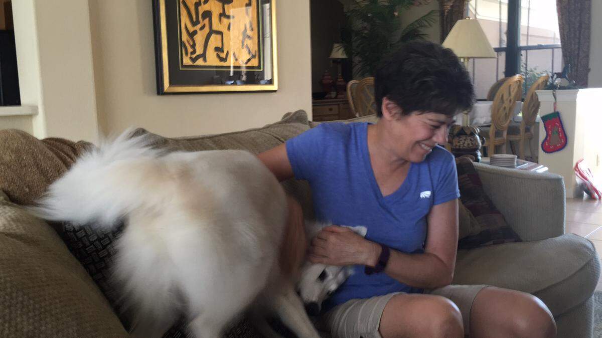 Dyan Laphan shares a special moment with Sami, one of the three American Eskimo dogs she and her husband, Dennis, live with in their River Club home. The Laphans say dogs contribute to their overall health by relieving stress and providing unconditional love and fun.RICHARD DYMOND/Bradenton Herald