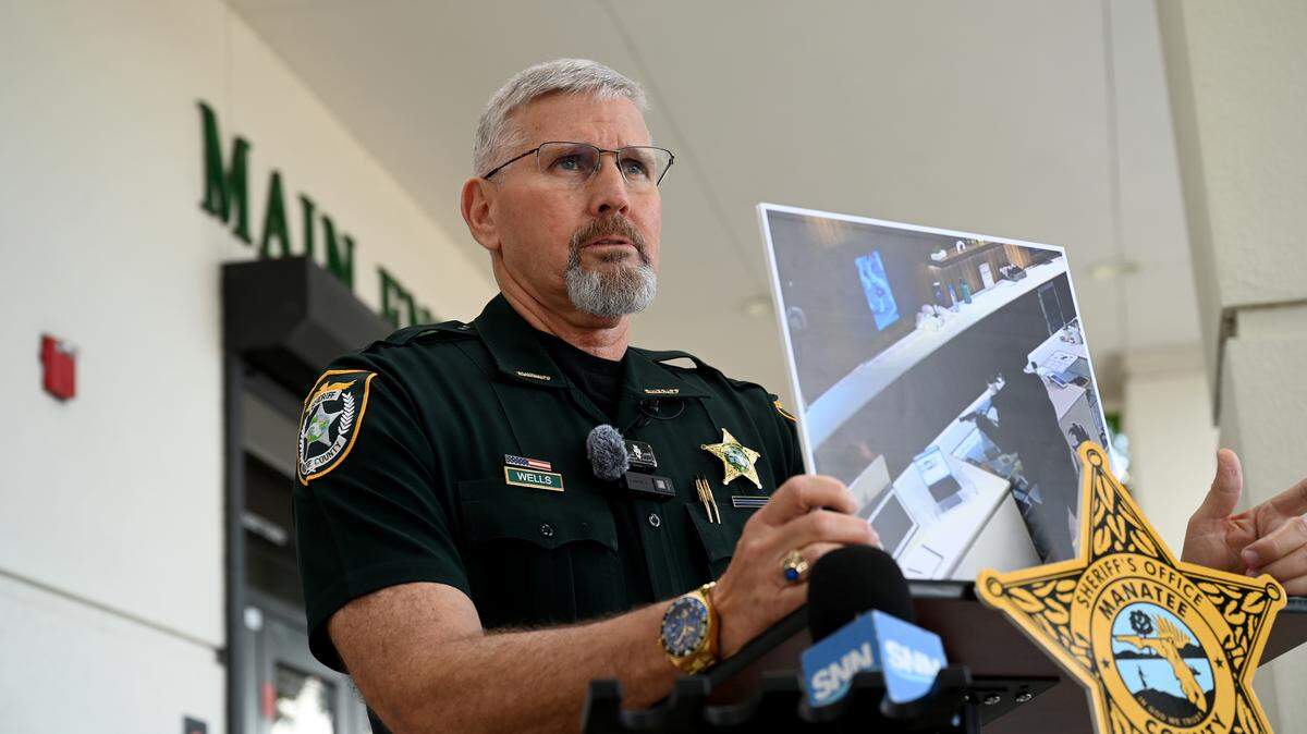 Manatee County Sheriff Rick Wells holds a photo of a suspect who hid in his home during an hours-long standoff in the 800 block of 63rd Avenue West on September 10, 2025. 