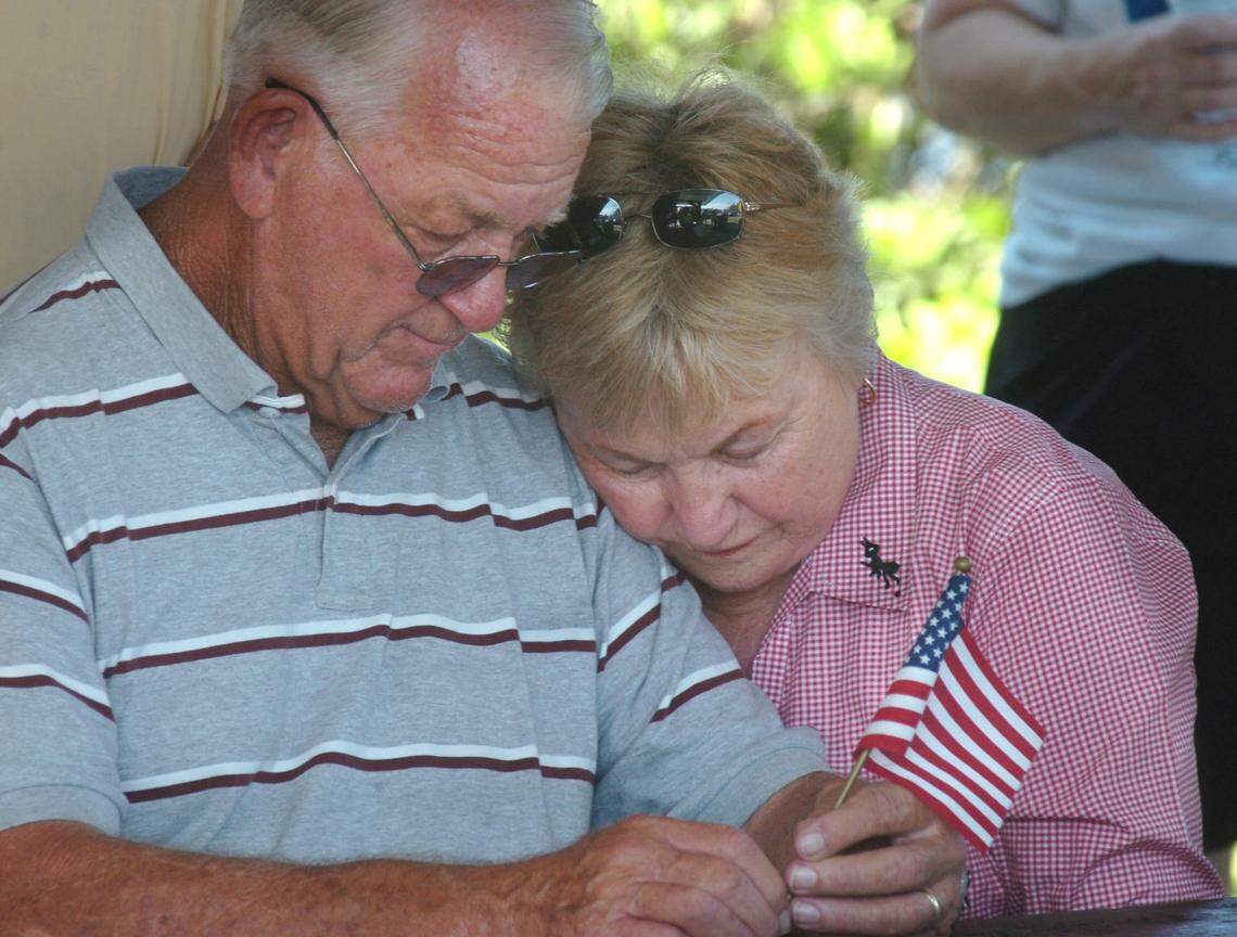 Ken Burton Sr. and his wife Judy, pause for a prayer as members of the Tea Party Manatee held a "Be Seen" rally in Palmetto in 2010.