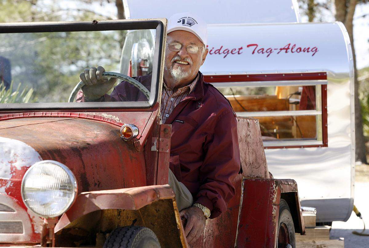 Lawrence Perry sits in his American-manufactured 1956 King Midget which can pull the 200 pound trailer he made which has a small bed and slide-out kitchen at Lake Manatee where the Tin Can Tourists gathered in 2010.