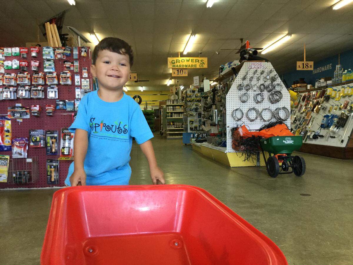 Kaden Fritz, 3, plays inside Growers Hardware as the owners announce the historic family business will be closing soon. Growers has been open for almost a century and never lost that “family store” flavor where kids were welcome to play and more often than not a family dog greeted you at the door.