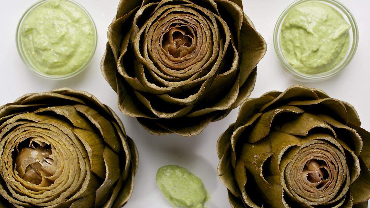 Steamed artichokes with saffron yogurt dip. DEB LINDSEY/THE WASHINGTON POST