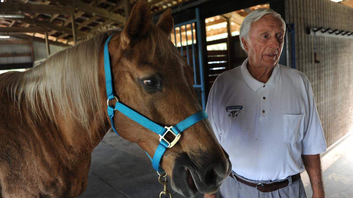 Ed "Mr. Ed" McAdam, owner of Longbranch Stables, stands with his horse, Rambo, at his stables in Parrish. McAdam, like many horse owners in the area, is keeping a close eye on the events surrounding the recent slaughter of a 12-year-old prize show jumper from Europe named Phedras de Blondel at Imperial Farms Equestrian Center. 
 GRANT JEFFERIES/Bradenton Herald