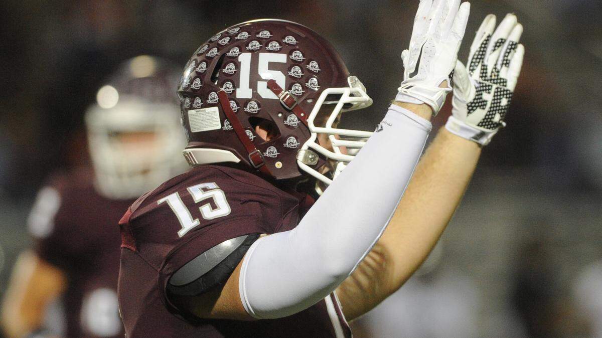 Braden River's Dylan Tyson raises his arms after the Pirates scored a field goal as the Pirates host the Sharks in a Class 7A-Region 3 quarterfinal Friday at Braden River. 
 GRANT JEFFERIES/Bradenton Herald