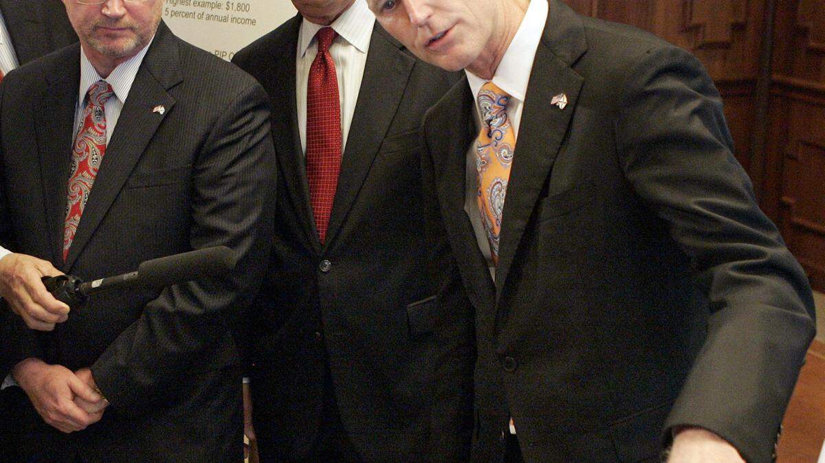 From left, insurance commissioner Kevin McCarty, CFO Jeff Atwater and Gov. Rick Scott hold a news conference to explain the situation concerning Pip auto insurance March 8, 2012, in Tallahassee, Fla. (AP Photo/Steve Cannon)