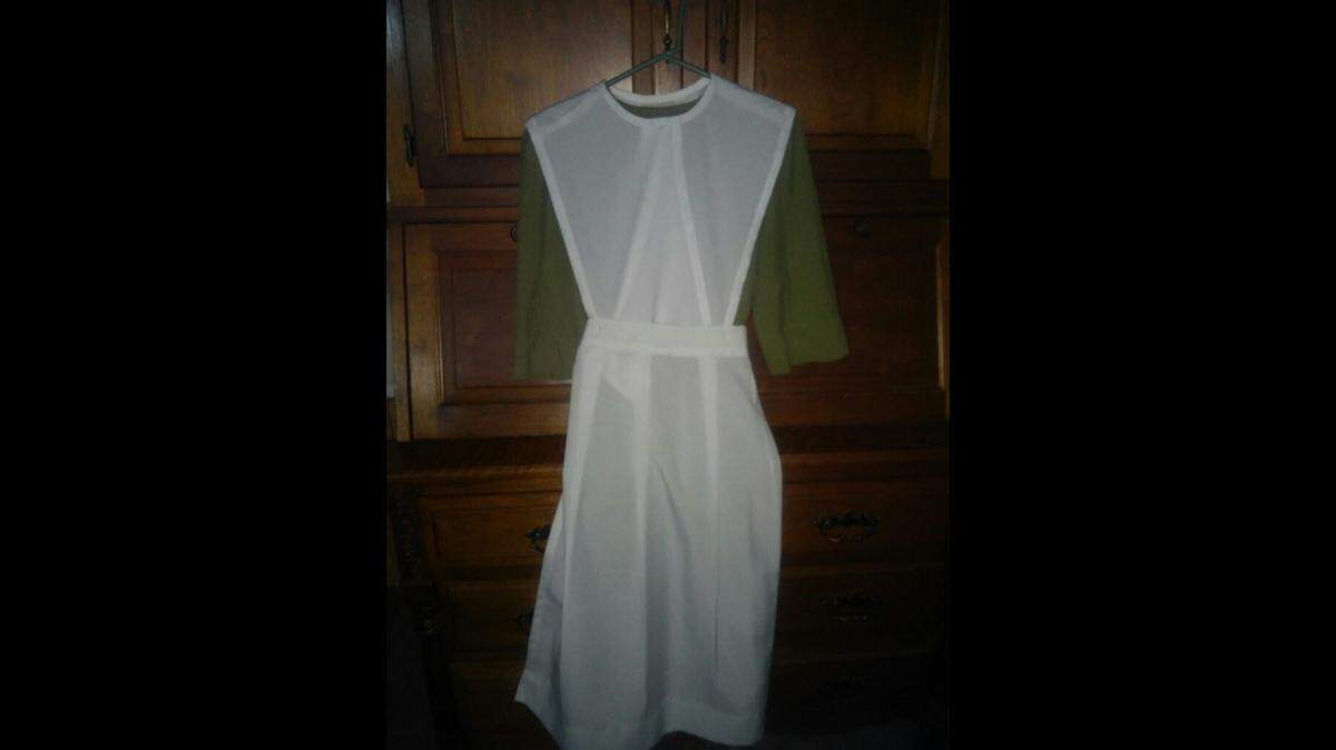 A dress ready for an Amish wedding showing the cape, apron and basic dress.