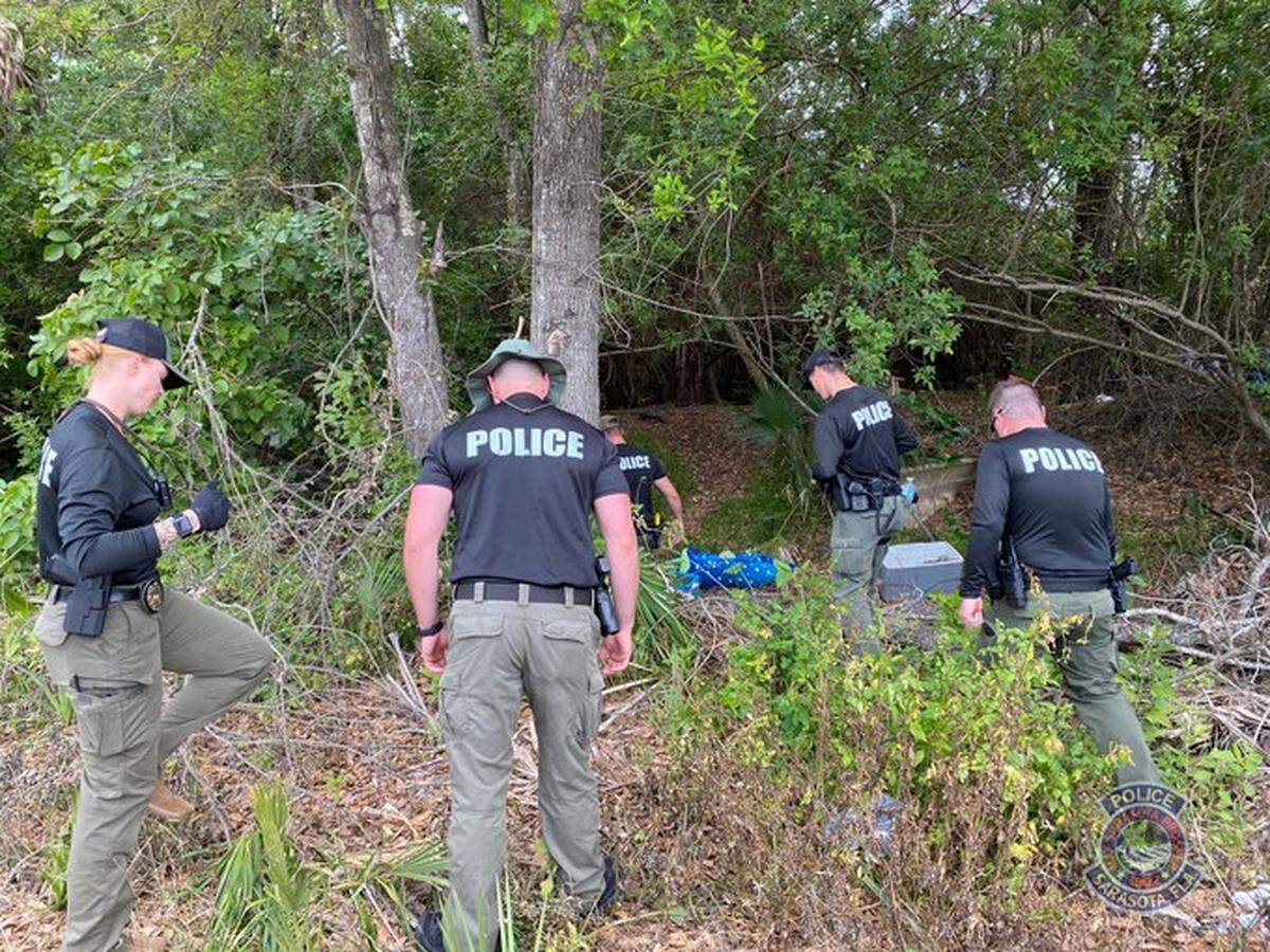 Sarasota police detectives investigating in the wooded area just north of the 10th Street boat ramp in Centennial Park off of North Tamiami Trail where Kellianne Ripley’s body was found on February 25.