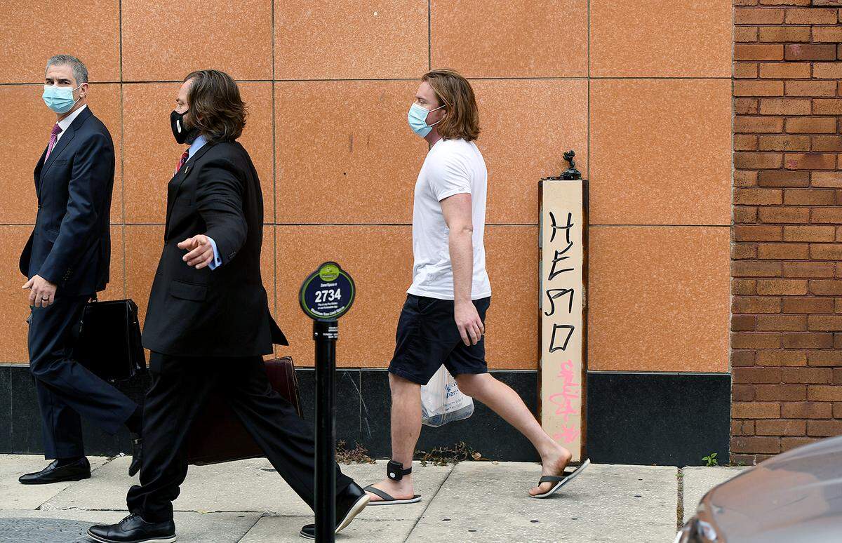 FILE: 01/11/20--Adam Johnson, right in shorts, leaves the Tampa Federal Courthouse with attorneys after a first appearance on charges stemming from the riot on the Capitol on January 6.