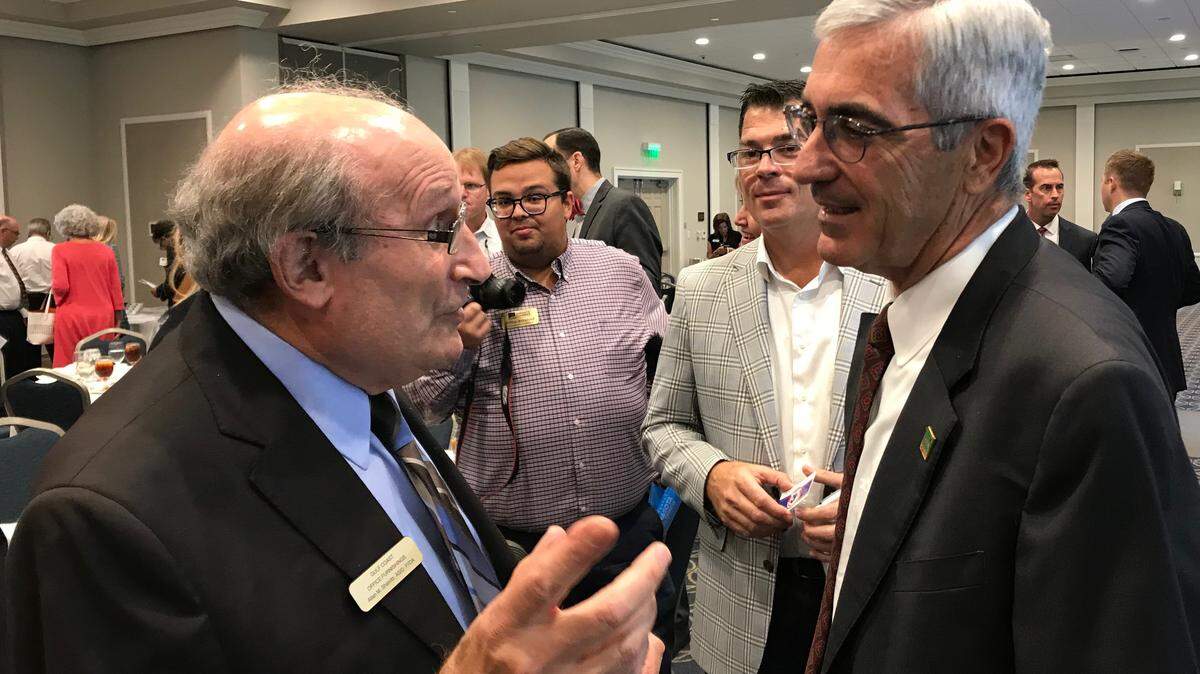 Allan Shavitz. left, of Lakewood Ranch, was one of those who gathered around Rick Piccolo, chief executive of Sarasota Bradenton International Airport, after his State of the Community Address on Wednesday.