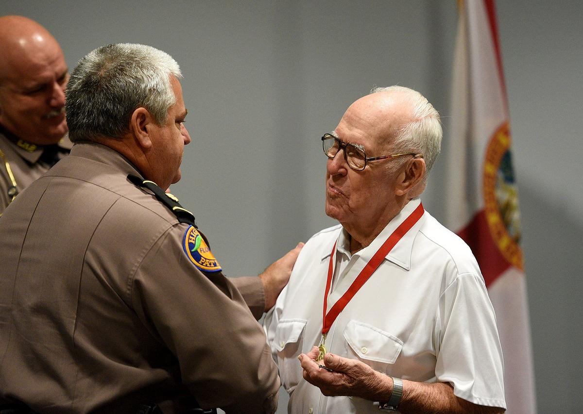 The Florida Highway Patrol, on behalf of Gov. Rick Scott, presents Dale Young the Governors Veterans Service Award. Young, a decorated World War II Veteran, served in the US Army from August 1944 to November 1946. Young is the father of Trooper Jeff Young, who was killed in the line of duty while attempting to arrest a drug courier during a traffic stop in Manatee County on August 18, 1987.