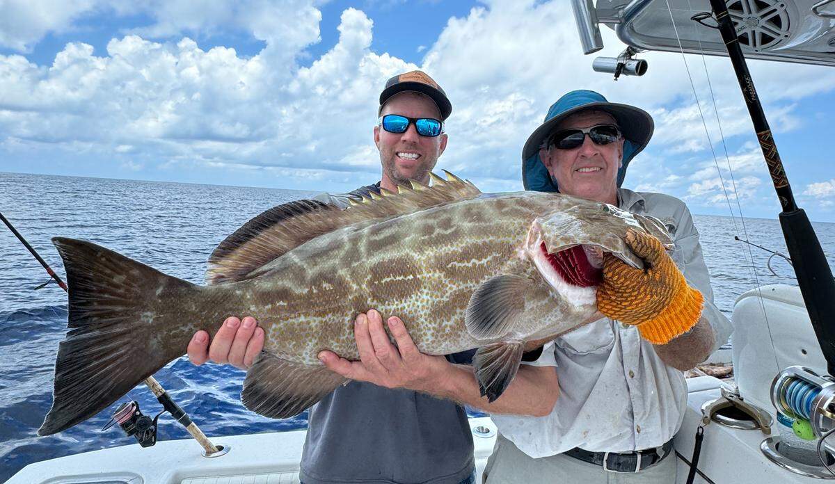 Jon Chapman and Rob Chapman III pose with a carbo grouper caught fishing in 200 feet of water in the Gulf of Mexico on Father’s Day, June 16, 2024.