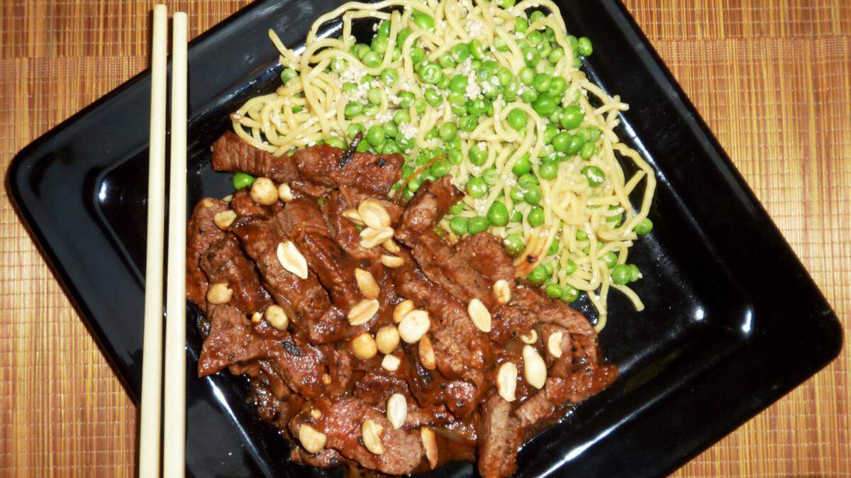 Hot and spicy stir-fried beef and basil shrimp pasta comes together in a snap. TNS