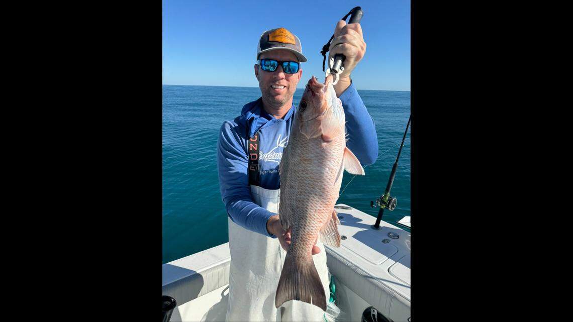 Jon Chapman poses with a mangrove snapper caught fishing Wednesday afternoon in 80 feet of water in the Gulf of Mexico on Wednesday, March 12, 2025.