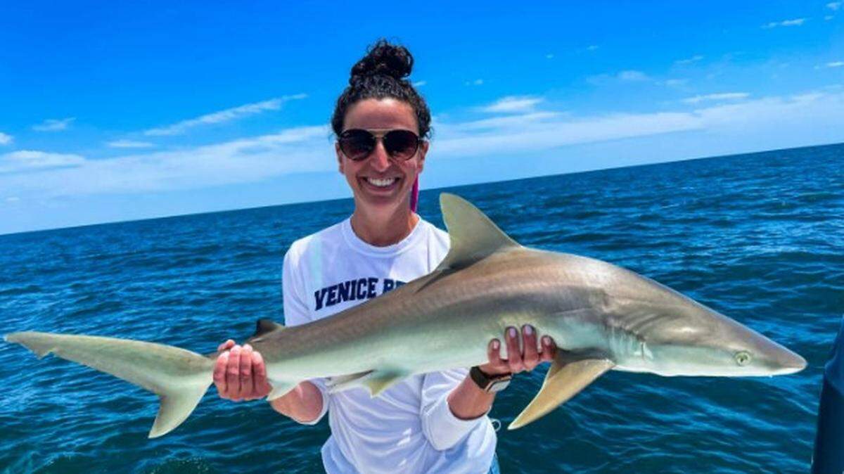A woman holds up a Blacknose shark she caught while on a fishing trip with Captain Tony Zain of Skyway Sportfishing, a charter service on Anna Maria Island. Zain is one of six charter boat fishermen named 2022 Angler’s Choice Award winners.
