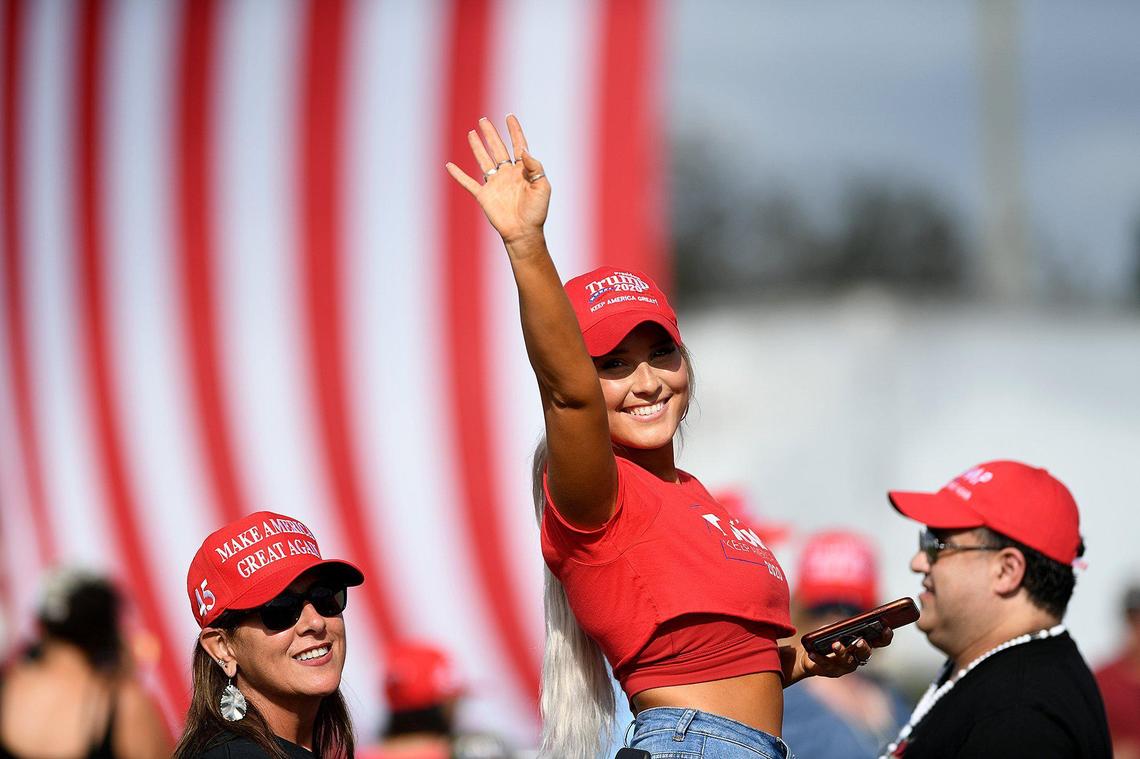 People arrive before President Trump holds a rally in a parking lot at Raymond James Stadium in Tampa October 29.