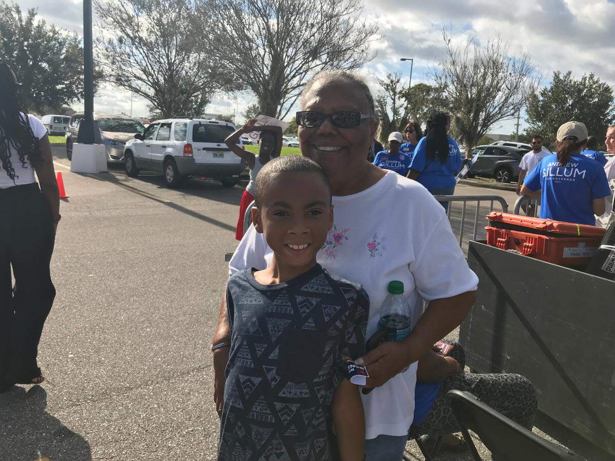 Eight-year-old Kenneth Smith poses in front of his grandmother, Jean Moreland. She said Kenneth was adamant about coming to see Andrew Gillum speak in Manatee on Saturday morning, so she picked him up from his house in Tampa so he could watch his role model speak.