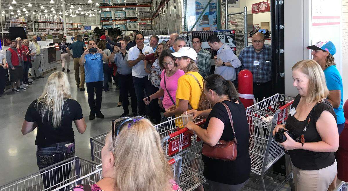 The first shoppers at the new Bradenton Costco Wholesale move into the warehouse in a wave three shopping carts wide on Wednesday.