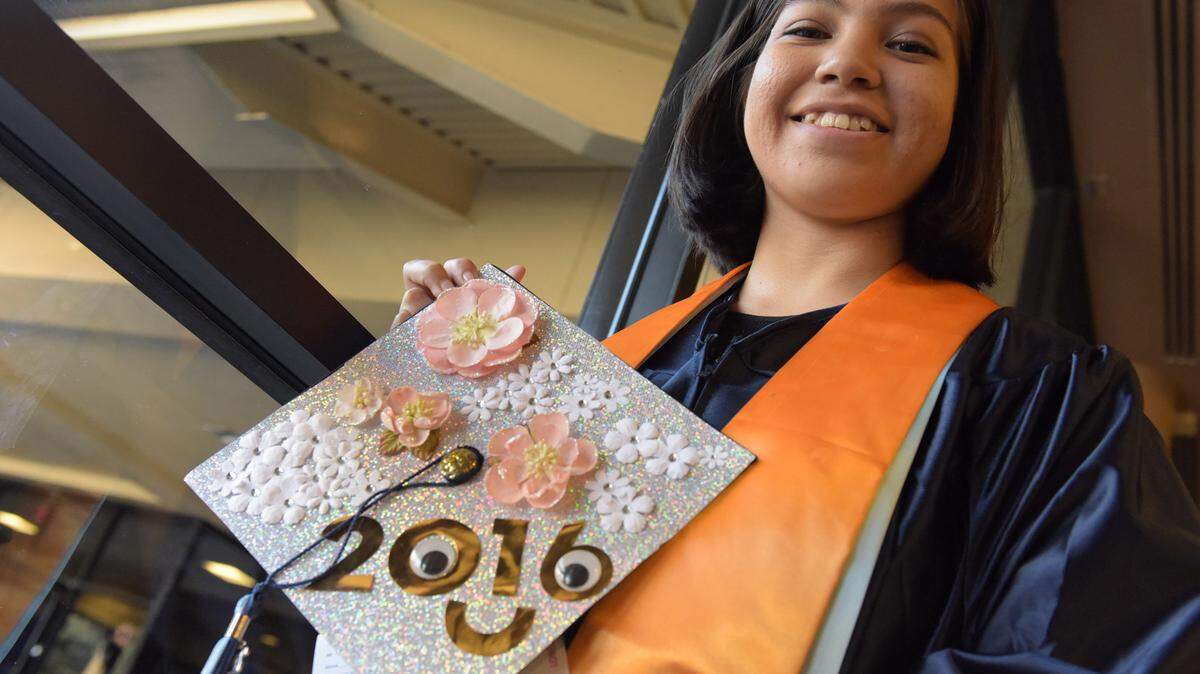 Olivia Doronio holds her decorated cap at the State College of Florida's graduation ceremony held at the Bradenton Area Convention Center Friday night. 
 TIFFANY TOMPKINS/Bradenton Herald