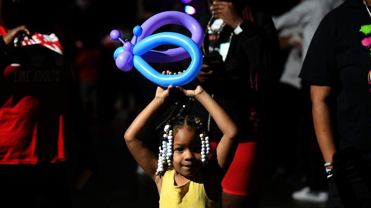 Clare Johnson, 3, plays with her balloon at the 37th annual Flight to the North Pole program for children with disabilities and terminal illness and their families. The event was founded by Sidney Ettedgui of the Manatee County Sheriff’s Office and Eastern Airline Flight attendants with the help of the Sarasota/Bradenton Airport Fire Dept. and Feld Entertainment.