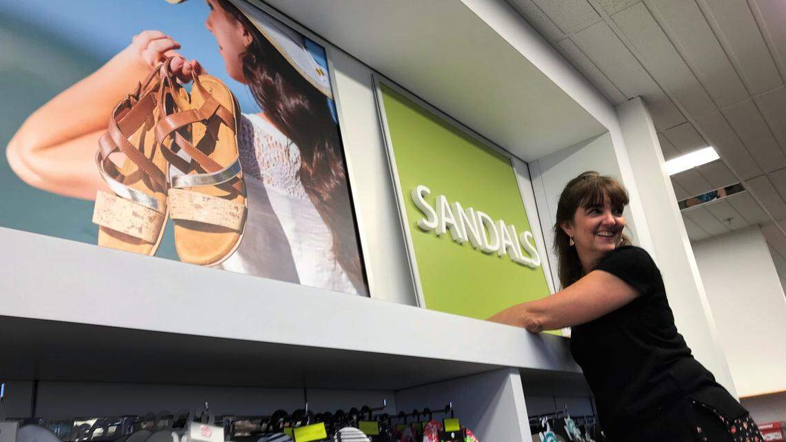 Bealls staffers were putting finishing touches on the flagship store at 6355 Manatee Ave. W., preparing for the grand reopening in October. Cheryl Allen is putting up a sign in the sandal department.