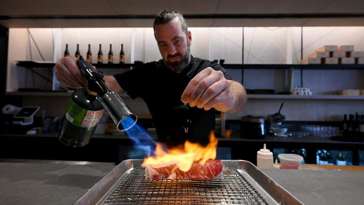 Chef Kurt Schauble applies fire to a Go roll, made with Wagyu beef, jumbo shrimp and shishito peppers at the newly-opened Kuro Sushi on Main Street in Lakewood Ranch on Nov. 4, 2025.
