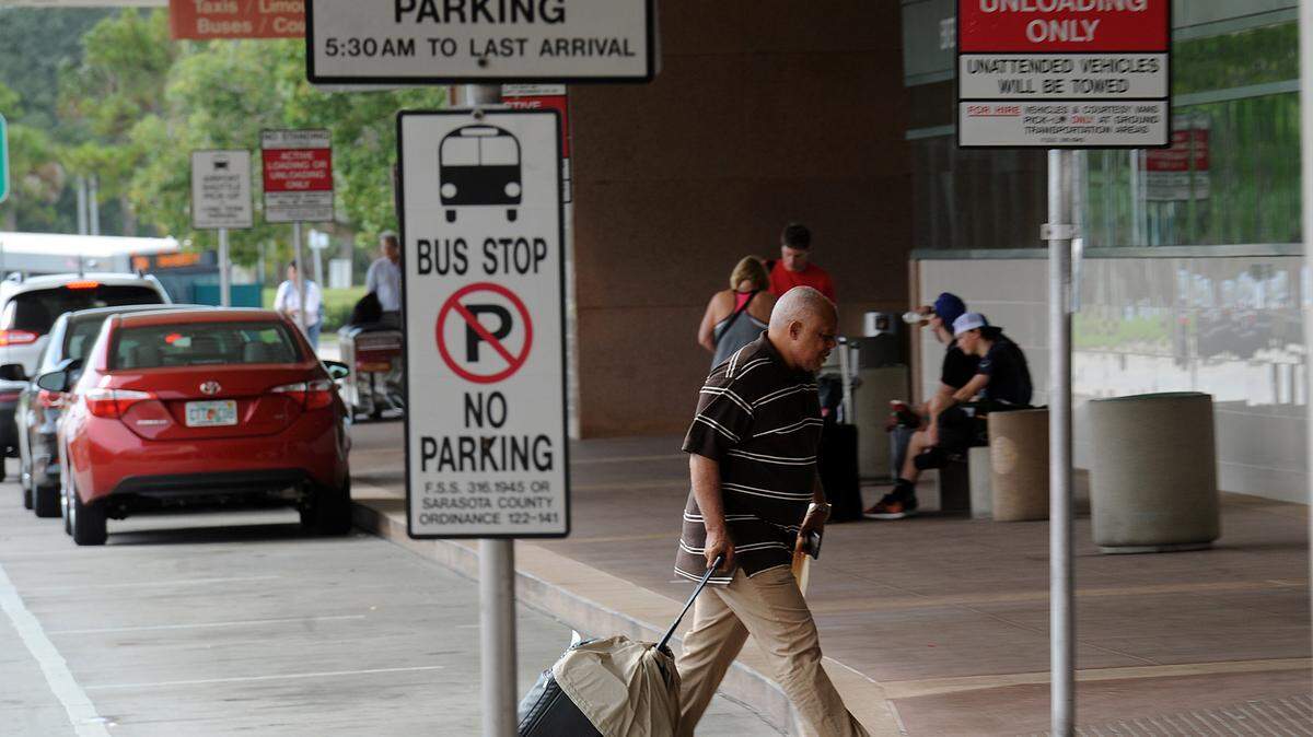 Passengers arrive at the Sarasota-Bradenton International Airport Wednesday. The airport is seeing an increase in travelers even though they have the same number of flights, 20, coming in and out of the airport. Mark Stuckey, the airport's vice president of special projects and development, said the flights more than 90 percent full for this holiday season. 
 TIFFANY TOMPKINS-CONDIE/Bradenton Herald