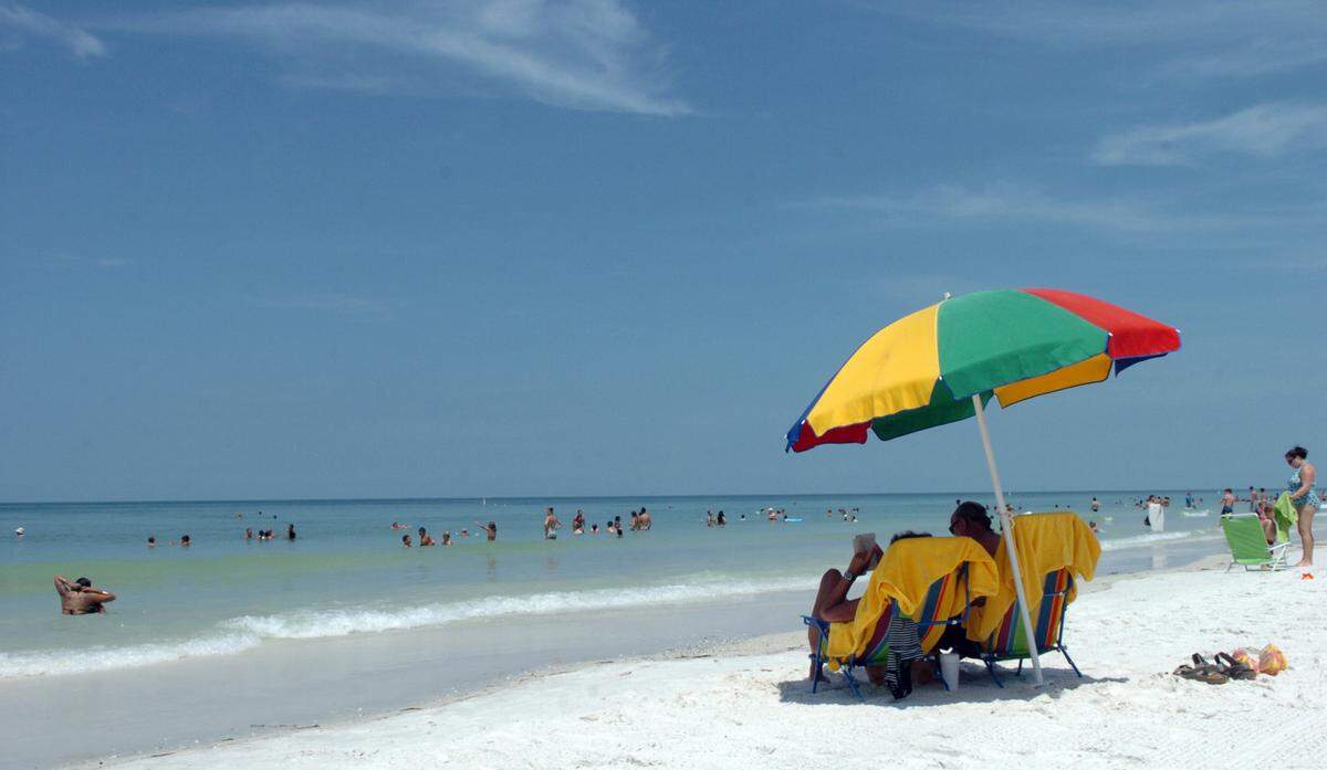 Beachgoers enjoy Manatee Public Beach in Holmes Beach on Anna Maria Island.