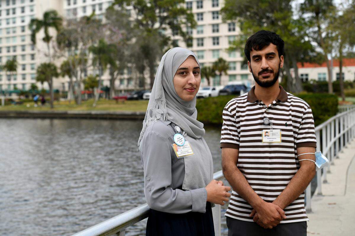 Noman Raoufi and his sister, Venus, at Westminster where they both now work after immigrating from Afghanistan.