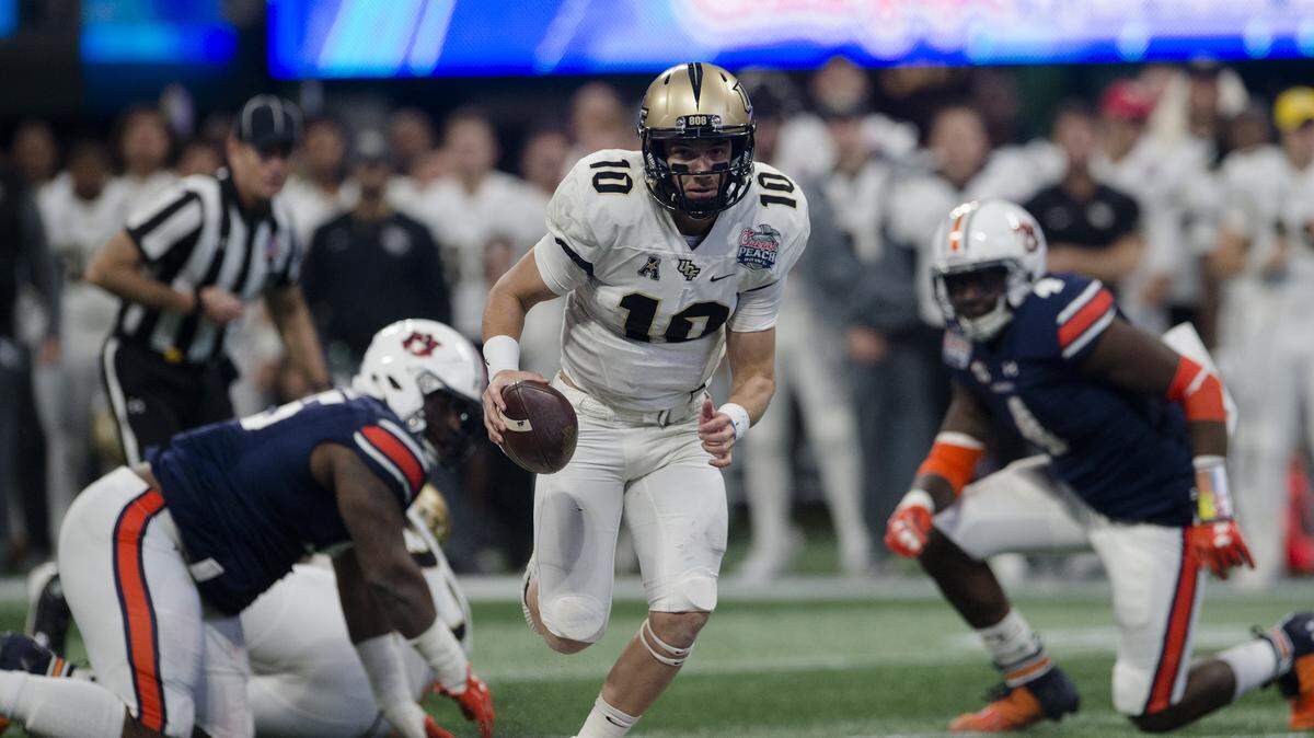 UCF quarterback McKenzie Milton (10) runs for a touchdown against Auburn during the first half of the Peach Bowl NCAA college football game Monday, Jan. 1, 2018, in Atlanta, Ga.