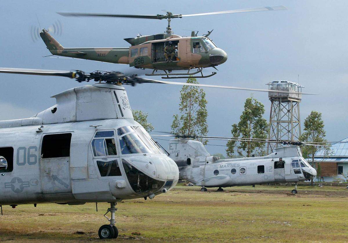 A Bell UH-1 Huey helicopter, top, is seen with United States Marine Chinook helicopters in Indonesia in 2005 after a tsunami.
