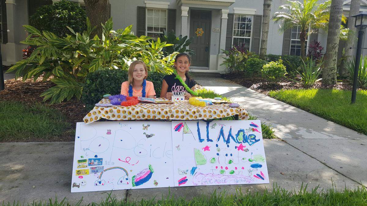 Riley Huelsman, 7 (left), and Emma Cowart, 8, are too young to volunteer for Manatee County Animal Services, so they made a popsicle stand to raise money for the animals instead.