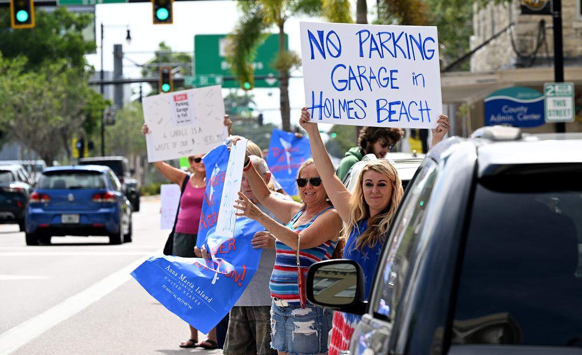 A group of about 50 demonstrators held signs in downtown Bradenton Friday in protest of a parking garage on Anna Maria Island. Gov. Ron DeSantis signed a law Friday that allows Manatee County to build Anna Maria Island beach parking garage despite protests from residents.