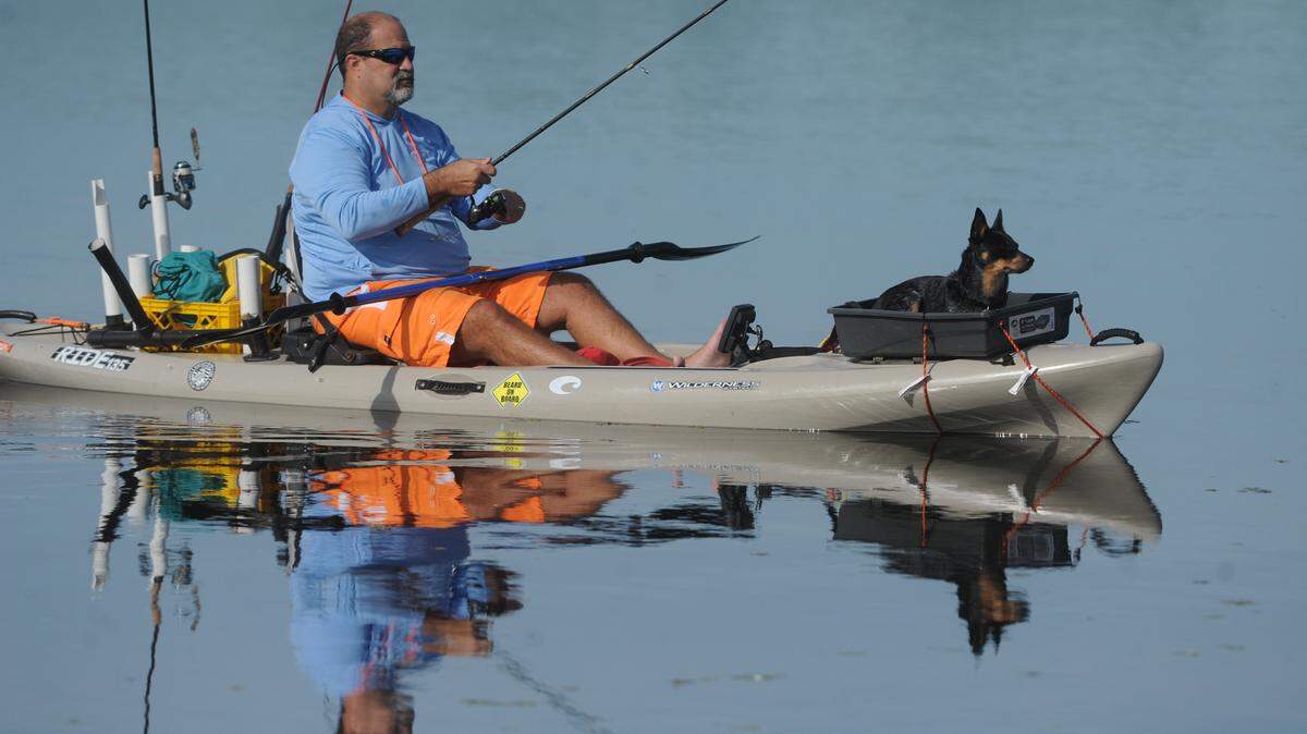 Heroes on the Water volunteer and U. S. Marine Corp. veteran, Ben Hall, fishes from a kayak with his dog, Shelby, in the Braden River as veterans and active military gather at Jiggs Landing on Saturday. Heroes on the Water provides a friendly and understanding environment for veterans and their families, to take a break from the stresses of combat or rehabilitation, using kayaks, fishing and just being out on the water.