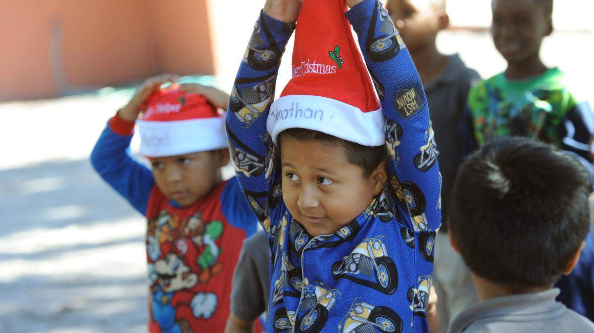 Students at the Visible Men Academy, a charter school for at-risk boys, rehearse for the schools multicultural holiday celebration on Thursday. The students, who normally wear uniforms, were dressed in their pajamas to observe Pajama-Polar Express Day. 
 GRANT JEFFERIES/Bradenton Herald