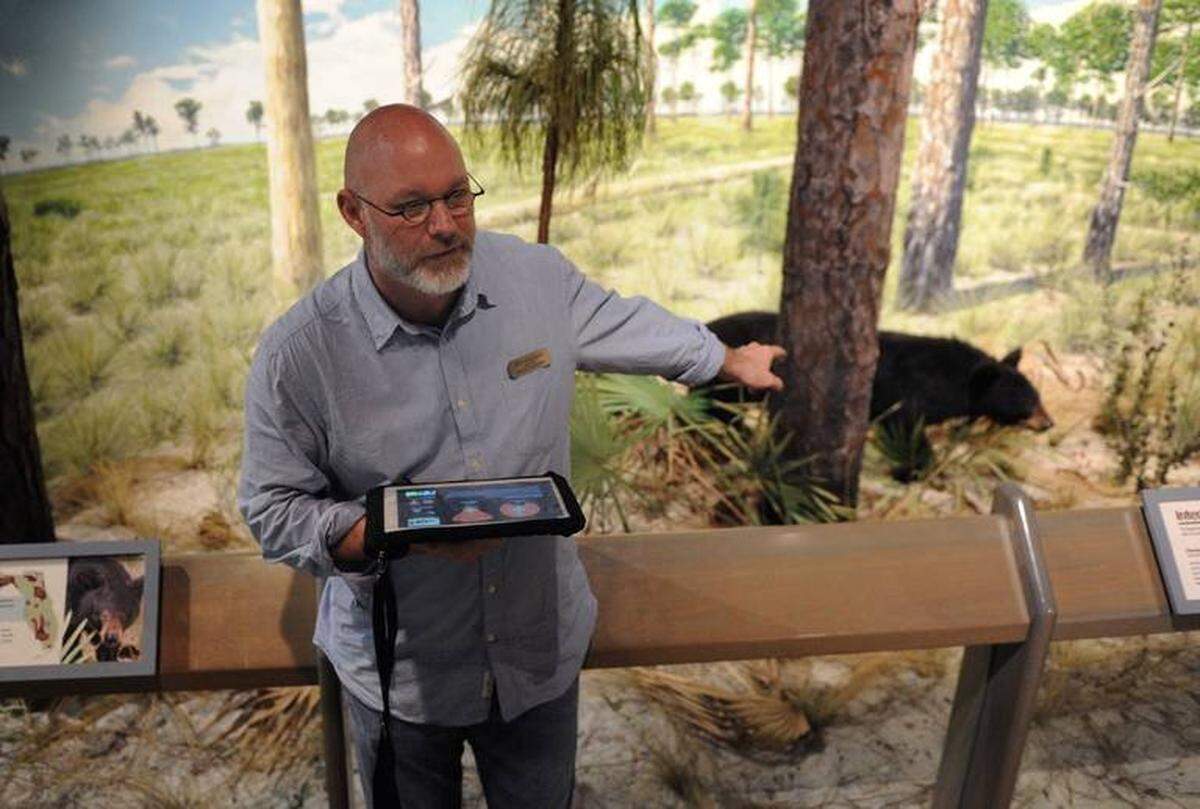 The Pathways program at South Florida Museum has been seven years in the making. Pictured: Museum provost Jeff Rodgers holds a tablet displaying a previous version of the program.