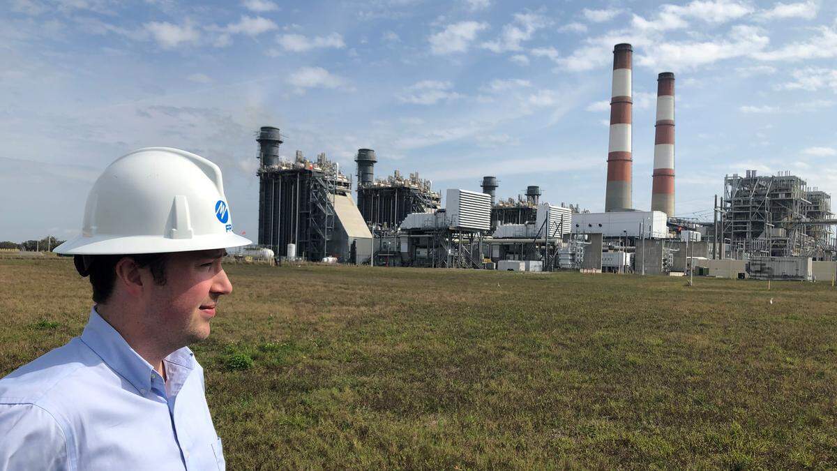 Twin red-and-white smoke stacks, a fixture at the Manatee FPL plant in Parrish since the 1970s, are expected to become a thing of the past in 2022 after the world’s largest battery is pressed into service to capture power generated by FPL’s nearby solar field. Shown above is Chris McGrath, a spokesman for FPL.