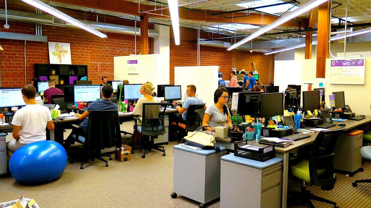 Co-workers at DeskHub sit next to each other at assigned desks that they pay for per month. There's a minimal amount of storage, but several spaces to congregate. Photo courtesy DeskHub/TNS
