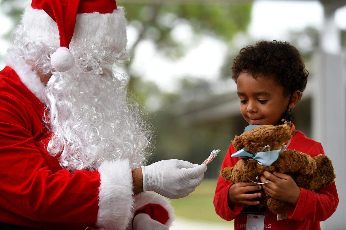 12/20/21—Kingston Cooper received a fluffy bear from Santa and a candy cane. Santa arrived on an East Manatee Fire Rescue truck to delight of pre-kindergarteners and ESE students at Bashaw Elementary School.