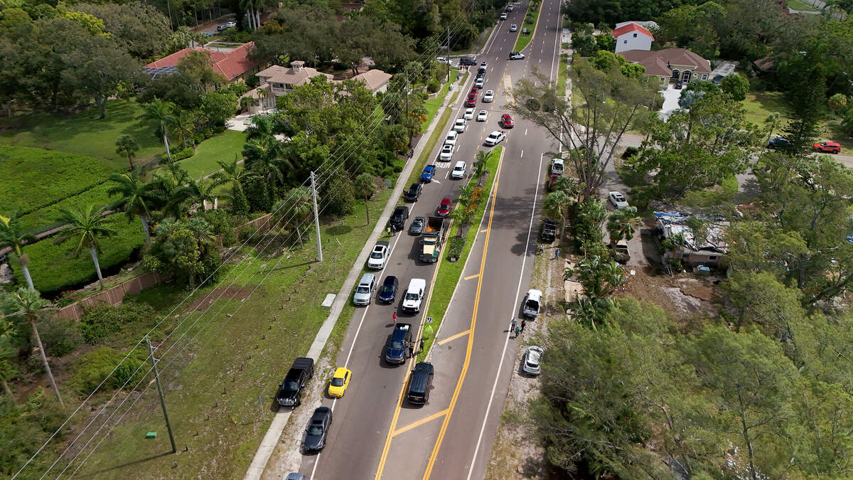Cars line up to cross the Palma Sola Causeway at a roadblock in the aftermath of Hurricane Helene in Manatee County on Friday, Sept. 27, 2024.