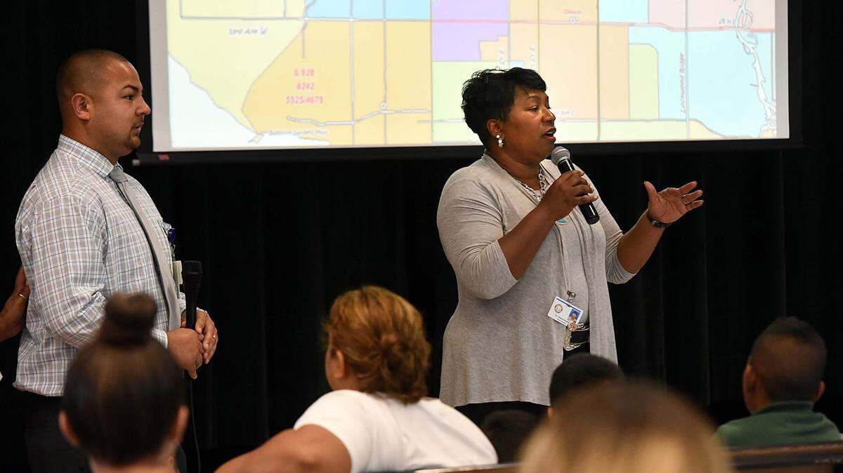 Manatee County Schools Superintendent Diana Greene, with translator Roberto Longoria, addresses parents at Rogers Garden Elementary School, telling them that the attendance zones are changing, with most of the students from Orange Ridge/Bullock Elementary coming to that location next year. 
 TIFFANY TOMPKINS/Bradenton Herald