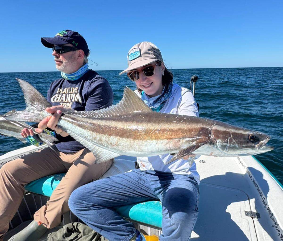 Avah Grace Meadows (right) and her father Dr. George Meadows pose with a pair of cobia caught in the Gulf while fishing with captain Jonathan Soultatos.