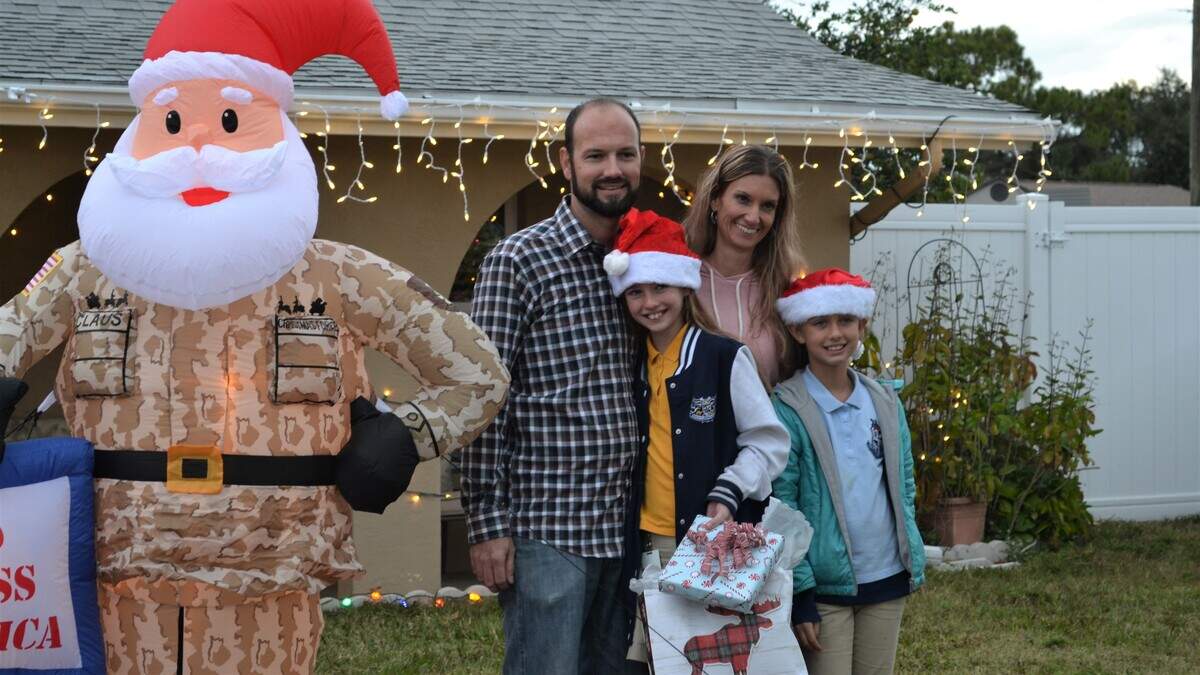The Landis family stands in their front yard in Bradenton after their home was decorated by Florida Power and Light volunteers.