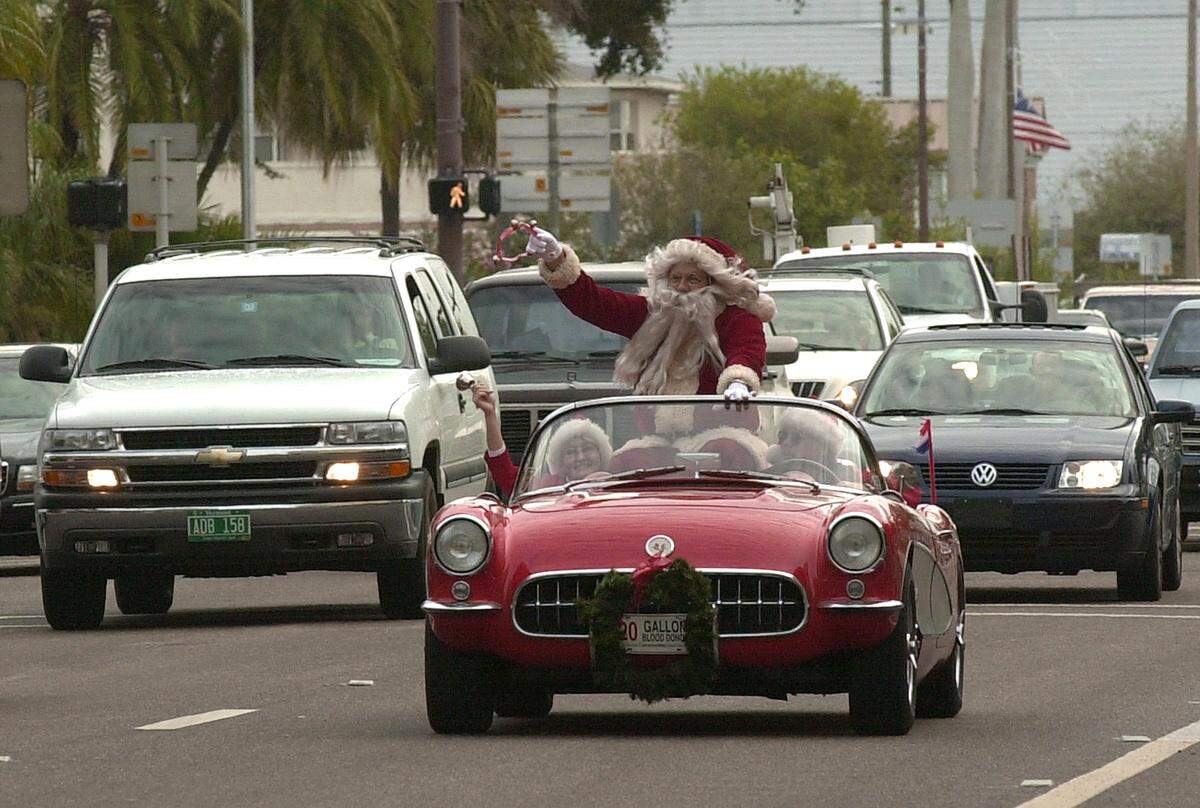 Santa Claus, (Greg Marme) rode around downtown Bradenton with helpers Dorathe Hartwell and Bill Herron wishing everyone happy holidays before going to a Christmas party for children at Champs corporate office on Manatee Avenue, 2001.